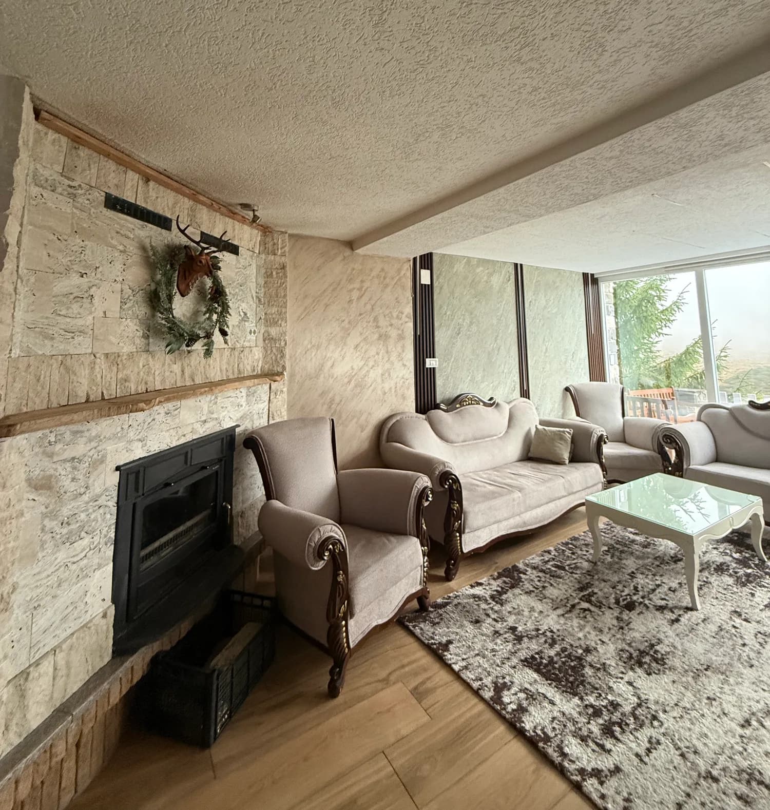 Sofas and a glass coffee table beside the fireplace at Villa Noar II